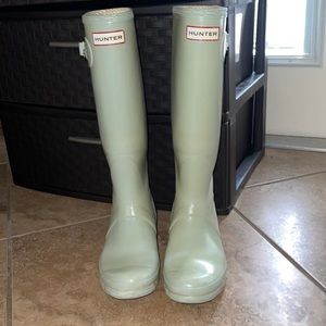 Hunter rain boots. They are faded teal color.